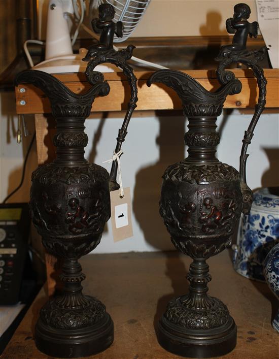Pair of classical style bacchanalian bronze ewers, 18in.(-)